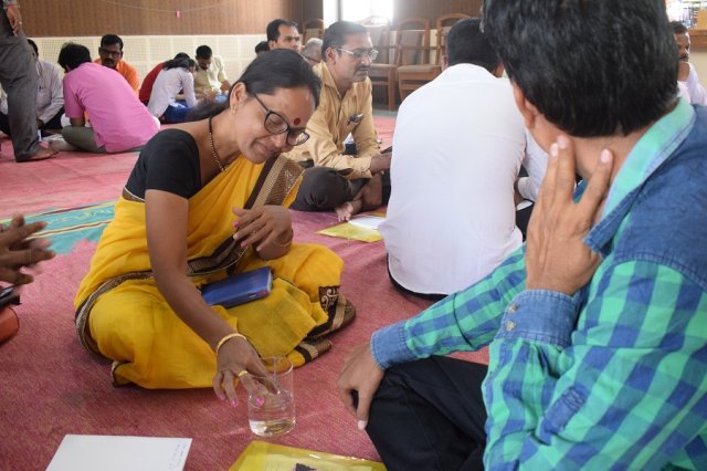 Teacher checking the flow of heat in liquid.